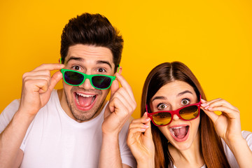 Close-up portrait of his he her she two nice attractive lovely charming stylish trendy cheerful cheery people opened mouth isolated over vivid shine bright yellow background