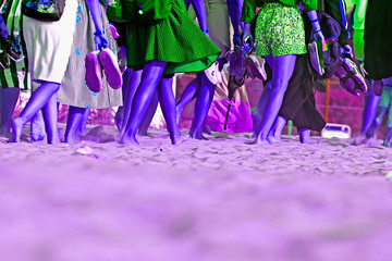 crowd of tourists walking barefoot in pop art along the beach
