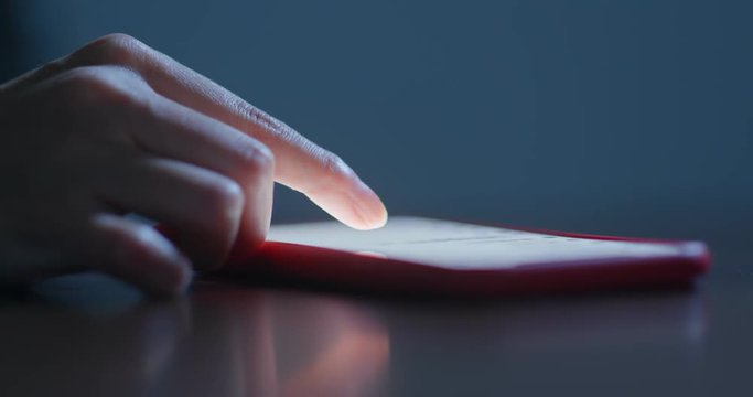 Finger touch on the cellphone at night