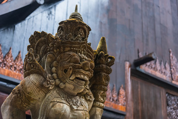 Balinese Carved Stone Statue of Rakasa covered with green moss.Thailand.
