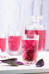 Turkish Ottoman drink sweet basil sherbet  in cut glass on white background with copy space.