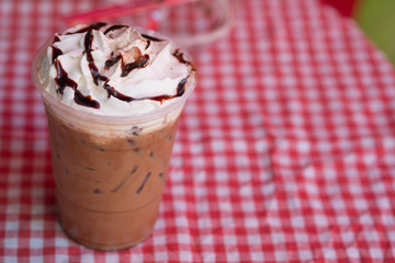 Chocolate sauce and whipped cream on top iced drink