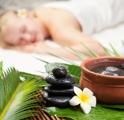 Obraz na płótnie Canvas Spa massage. Beautiful young woman getting spa massage. Focus on Spa objects