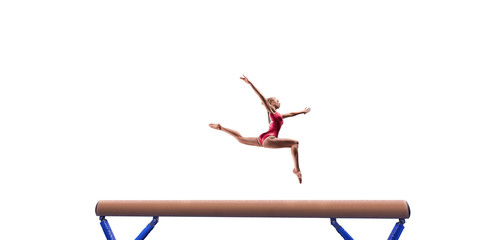 Female athlete doing a complicated exciting trick on gymnastics balance beam on white background. Isolated Girl perform stunt in bright sports clothes