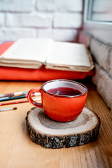 cup of tea and book on wooden table