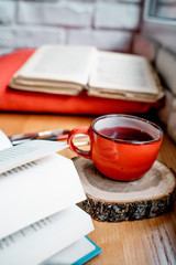 cup of tea and book on wooden table
