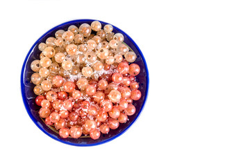 Fototapeta na wymiar Currant berries white and pink on a blue plate