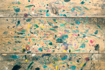 Top view. Old paint stained artist empty table. Artistic background
