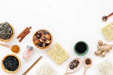 Chinese and Japanese food cooking with ginger, spices and noodles on white background top view mockup