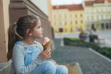 girl eating ice cream outdoor in town