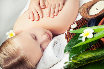 Spa relax massage concept. Beautiful young woman getting spa massage