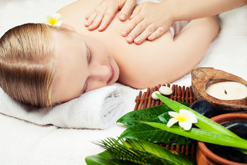Obraz na płótnie Canvas Spa massage with aromathrepy. Beautiful young woman getting spa massage. Spa concept