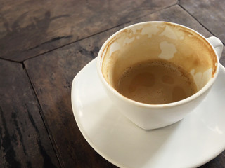 close-up coffee cup on wood table in coffee cafe.