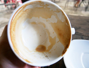 close-up coffee cup on wood table in coffee cafe.
