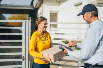 Delivery Service. Courier Delivering Package To Woman