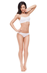 Fototapeta premium Fitness young woman with a beautiful body on white background