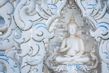 Fototapeta na wymiar White monk statue at white temple Wat Rong Khun, Chiangrai, Thailand.