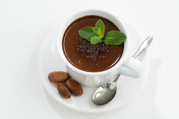 cup with hot mint chocolate on white table, top view