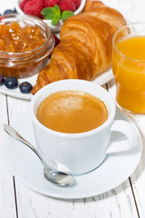 espresso and croissants for breakfast on white table