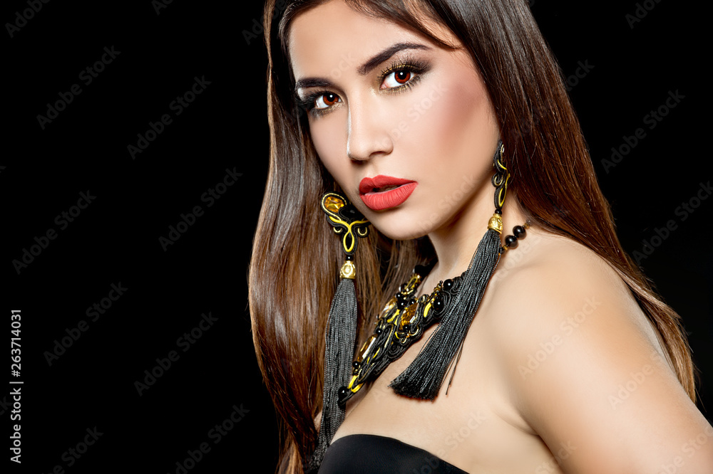 Wall mural beautiful woman with bright make up and with black earrings. bright make up. series