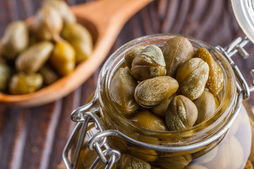 pickled capers on a wooden rustic background