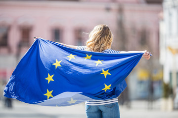 Attractive happy young girl with the flag of the European Union