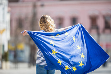 Attractive happy young girl with the flag of the European Union - obrazy, fototapety, plakaty