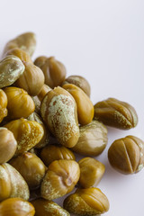 Pickled capers on a white acrylic background