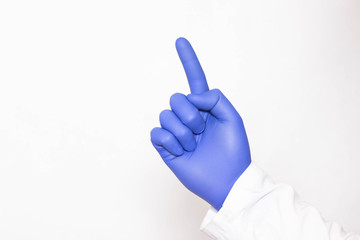 Gloved hand of doctor urologist on white background concept of massaging the prostate gland and...