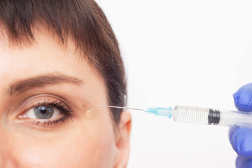 A cosmetologist injects a scar into a scar and a scar and uses hyaluronic acid for the resorption...