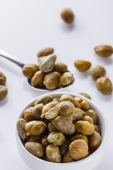 Pickled capers on a white acrylic background