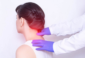 Doctor neurologist examines the patient's sore neck on a pinched nerve and protrusion of the spine, medical