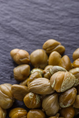pickled capers on a dark stone background
