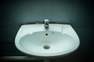 grungy restroom wash basin