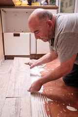 Bricklayer renovating the floor of a kitchen