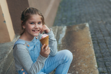 little girl eating ice cream in cone