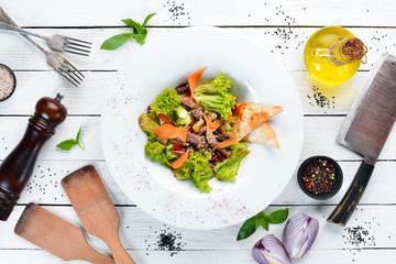 Vegetable salad with veal and mushrooms. In the plate. Top view. Free space for your text. Rustic style.