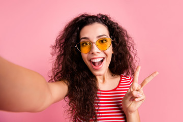 Self-portrait of her she nice-looking lovely sweet adorable attractive charming girlish cheerful cheery glad wavy-haired lady showing v-sign isolated over pink background