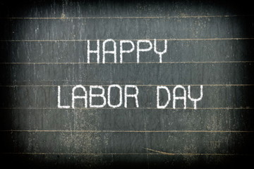Fototapeta na wymiar Happy Labor Day Chalking Writing on Blackboard.