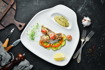 Baked fish fillet with vegetables. Top view. Free space for your text.