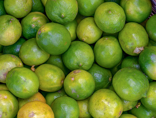 A heap of limes. Photographed at the local traditional market of the colonial town of Villa de Leyva in the Andean mountains of central Colombia.