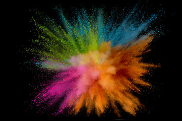 Colored powder explosion. Abstract closeup dust on backdrop. Colorful explode. Paint holi