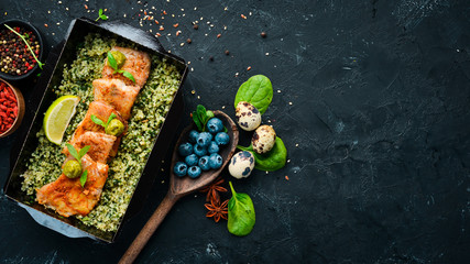 Baked fish fillet in tomato sauce with green buckwheat and spinach. restaurant dish delivery. Top view. Free space for your text.