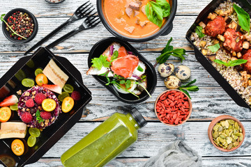 Delivery of food. Buckwheat, meat, fish, pumpkin soup. Top view. Free copy space.