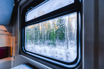 View of the window of a moving passenger train.