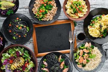 Food Background. Pasta, rice, risotto, salad. On a white wooden background. Free copy space.