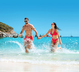 Young, attractive couple resting on a tropical beach
