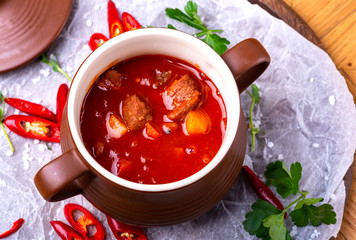Tasty Hungarian Hot Goulash Soup Bograch or Gulas Lamb Meat Stew on Wooden Surface at Restaurant. Traditional Food.