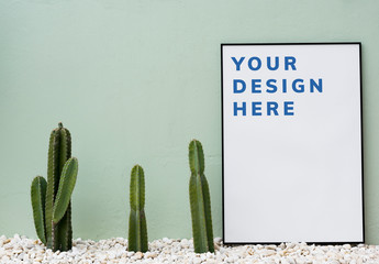 Poster Mockup Leaning on Green Wall with Cacti
