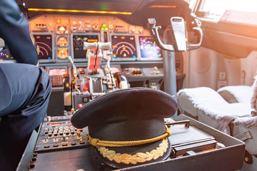 Cap of the commander of the aircraft in the cockpit. Civil Aviation Concept.